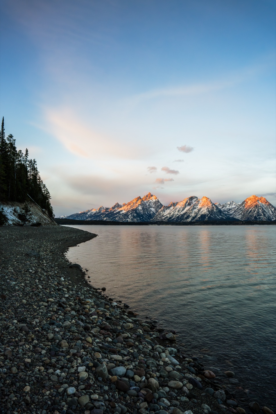 The Teton range at first light above a still lake
